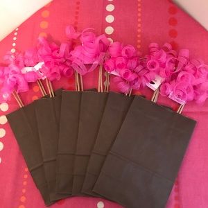 6 “Chocolate” colored gift bags, 6 pink glitter curly bows